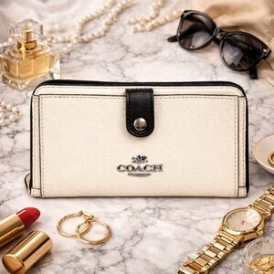 Coach F29940 cream and black color block zip around cross grain leather wallet.